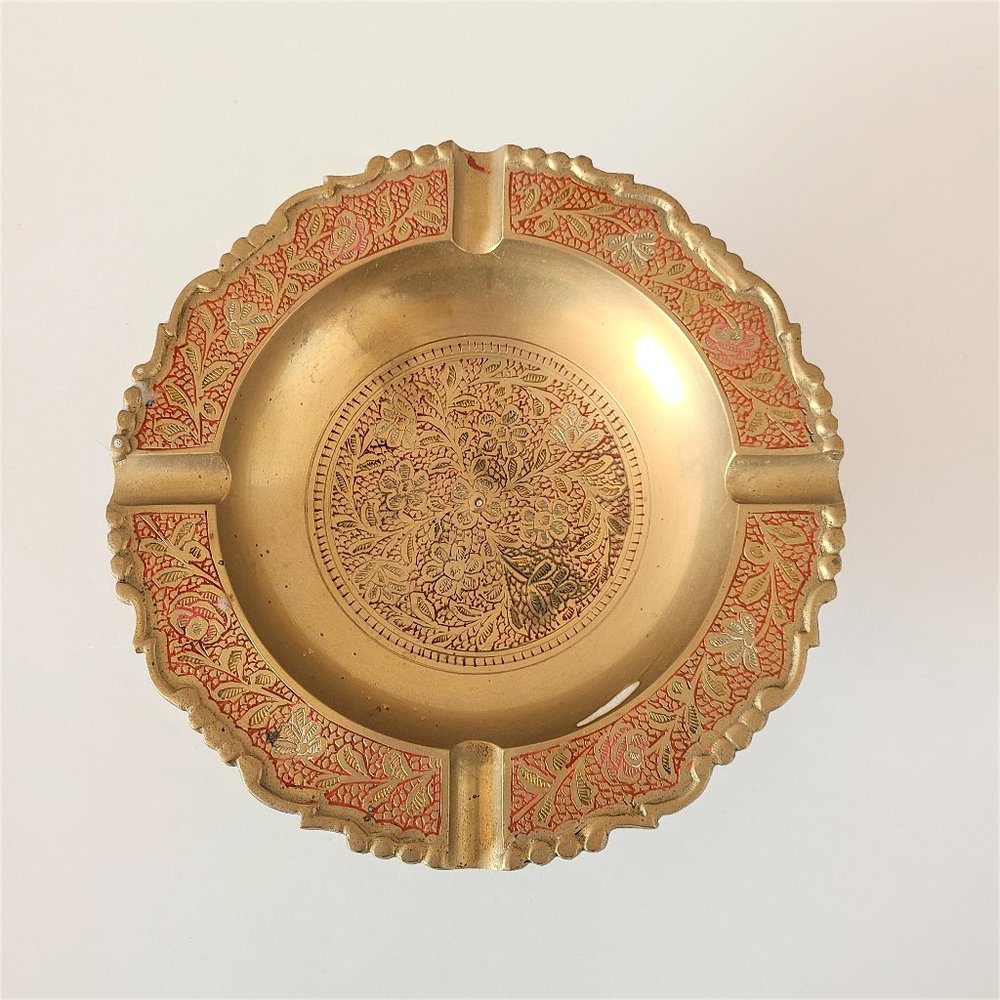 Vintage etched brass ashtray with red inlay.